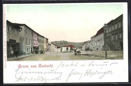 AK Haslach, Strassenpartie mit Geschäften und Bergblick, Karren, Panorama