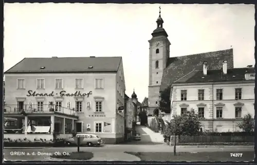 AK Grein, Strassenpartie mit Strand-Gasthof und Kirche