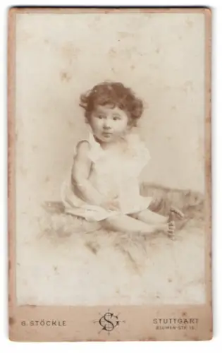 Fotografie G. Stöckle, Stuttgart, Blumen-Str. 19, Kind auf Fell sitzend
