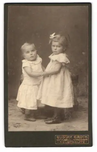 Fotografie Gustav Groth, Neustrelitz, Glambeckerstr. 9, Zwei kleine Kinder in weissen Kleidern