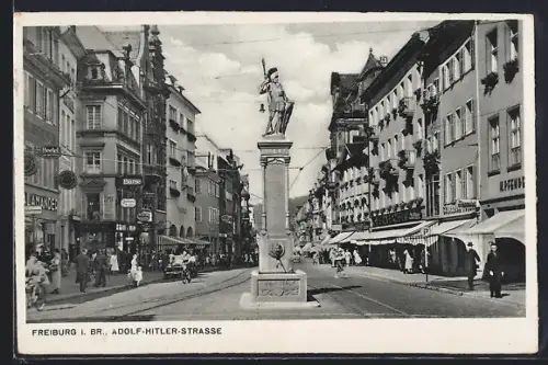 AK Freiburg i. Br., Strasse, Strassenansicht mit Statue