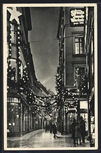 AK Magdeburg, Strassenpartie mit Geschäften im Weihnachtsschmuck