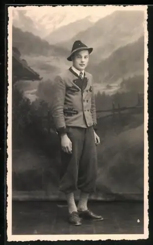 Foto-AK Junger Mann in traditioneller Kleidung vor einer Bergkulisse
