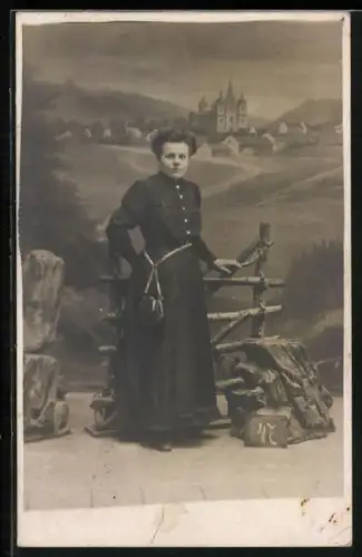 Foto-AK Dame in dunklem Kleid bei einem Zaun