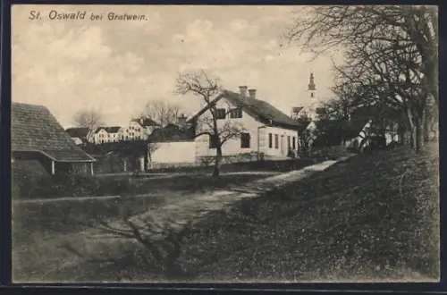 AK St. Oswald / Plankenwarth, Strassenpartie mit Blick zur Kirche