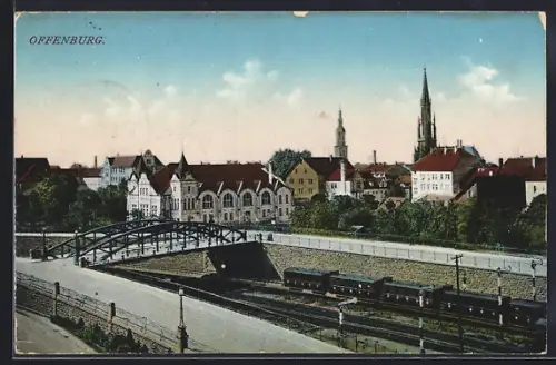 AK Offenburg, Stadtansicht mit Eisenbahnbrücke und Kirche