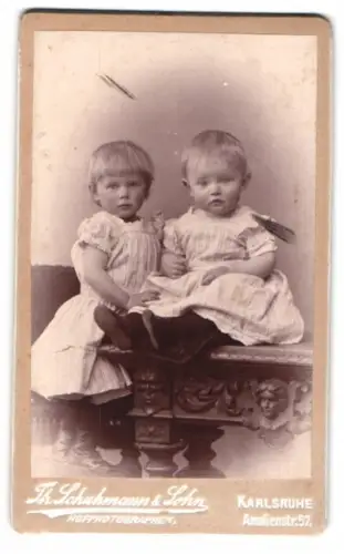 Fotografie Fr. Schuhmann & Sohn, Karlsruhe, Amalienstr. 57, Zwei Kleinkinder auf kunstvollem Tisch