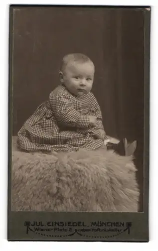Fotografie Jul. Einsiedel, München, Wiener Platz 2, Baby auf Fell