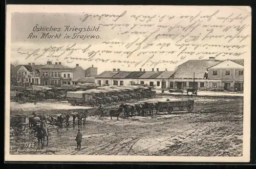 AK Grajewo, Markt mit Militär-LKW und Fuhrwerken, Häuserpanorama, Kriegsbild