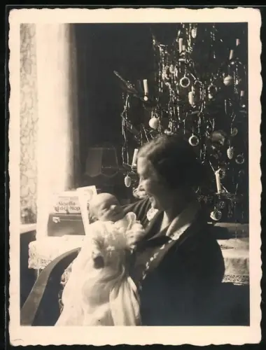 Fotografie Mutterglück, Mutter mit ihrem Neugeborenen an Weihnachten vor dem Weihnachtsbaum