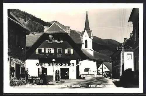 AK St. Johann am Tauern, Strassenpartie mit Geschäft von Karl Grassegger und Kirche