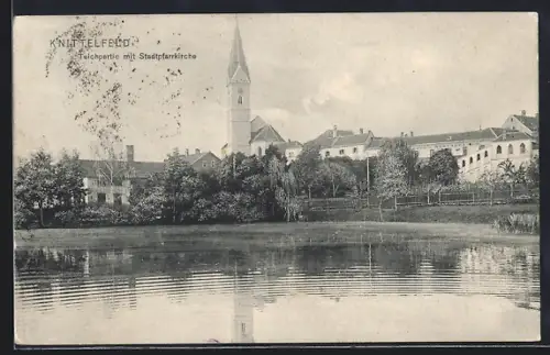 AK Knittelfeld, Stadtpfarrkirche vom Teich aus gesehen