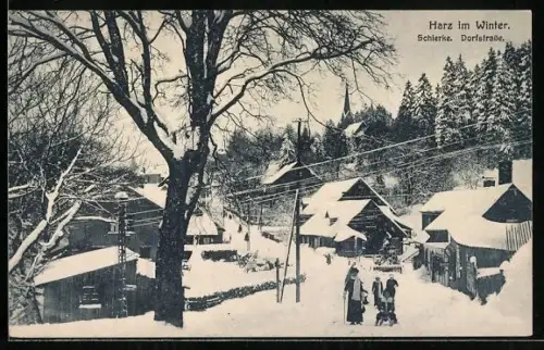 AK Schierke /Harz, Dorfstrasse mit Schlittenfahrer im Winter