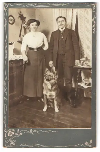 Fotografie junges Paar im heimischen Wohnzimmer mit ihrem Hund