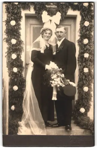 Fotografie Schmidt, Bautzen, Hochzeitsfoto vor blumengeschmücktem Eingang