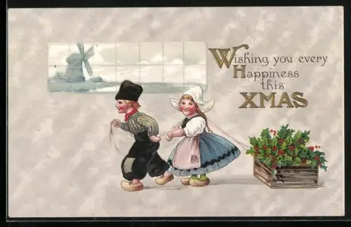 Präge-AK Kleines Holländisches Paar mit Kiste voller Stechpalmen, Windmühle, Weihnachtsgruss
