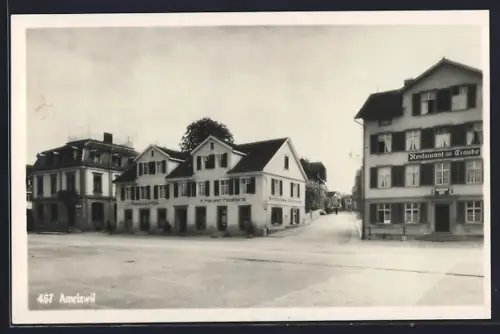 AK Amriswil, Strassenpartie mit Restaurant zur Traube, Restaurant Post und Papeterie K. Hauser