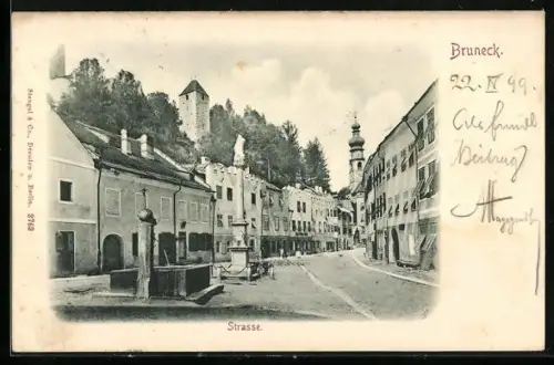 AK Bruneck, Strassenpartie mit Denkmal und Brunnen