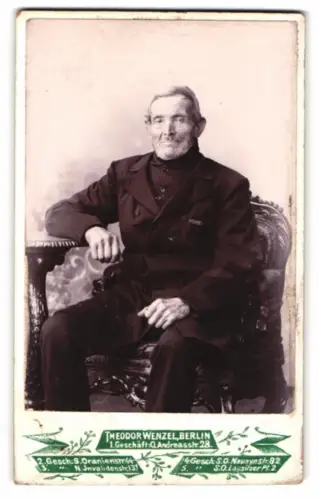 Fotografie Theodor Wenzel, Berlin, Andreasstrasse 28, Älterer Herr auf kunstvollem Stuhl