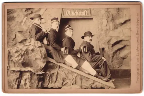 Fotografie P. Ney, Berchtesgaden, Besucher des Salzbergwerk als Bergleute auf Rutsche mit Lampen