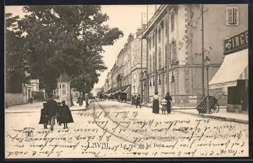 AK Laval, La rue de la Paix animée avec passants et bâtiments historiques