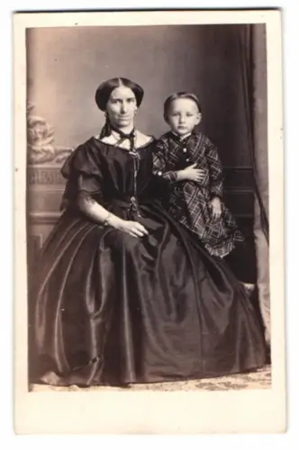 Fotografie A. Herrmuth, Berlin, Mutter im schwarzen Kleid mit ihrem Kind auf dem Schoss