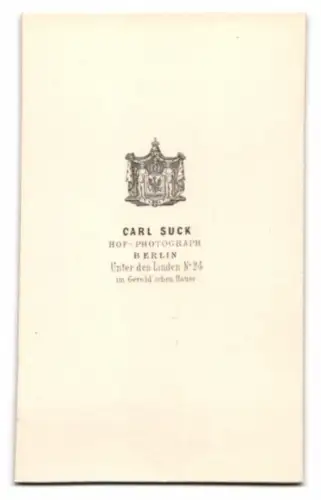 Fotografie Carl Suck, Berlin, Herr im feinen Anzug posiert vor einer Studiokulisse