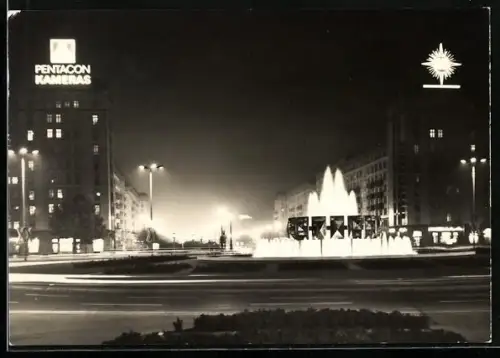 AK Berlin, Strausberger Platz mit Geschäfthäusern bei Nacht