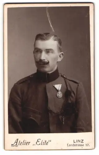 Fotografie Elite, Linz, K.u.K. Soldat in Uniform mit Orden an der Brust und Schützenschnur