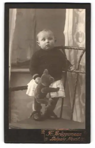 Fotografie Fr. Brüggemann, Leipzig, kleines Kind mit Stoff Teddybär