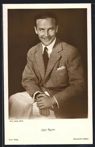 AK Schauspieler Igo Sym mit gekreuzten Beinen