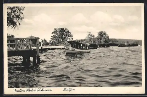 AK Eutin /Holst. Schweiz, See Ufer mit Boot Freischütz