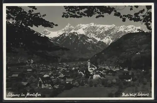 Foto-AK Schruns in Montafon, Ortsansicht mit Kirche überragt von der Gebirgskette