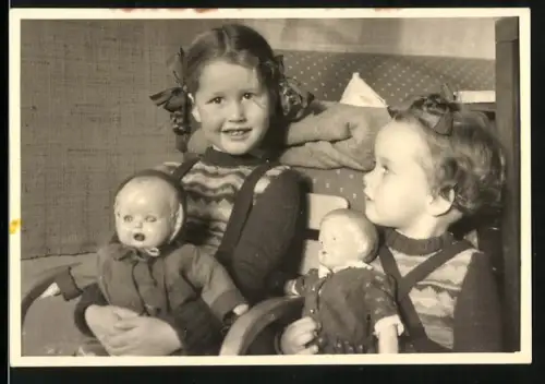 Fotografie zwei niedliche Mädchen mit ihren Puppen