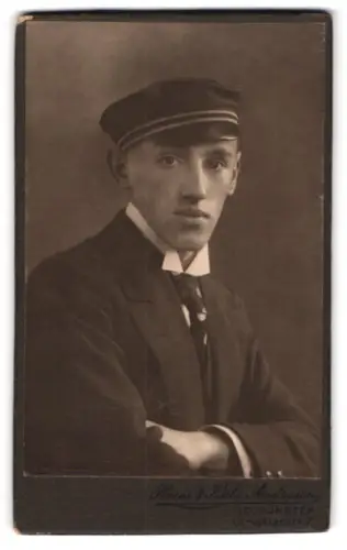 Fotografie Heinr. & Käthe Andersen, Neumünster, Student im Anzug mit Couler an der Mütze