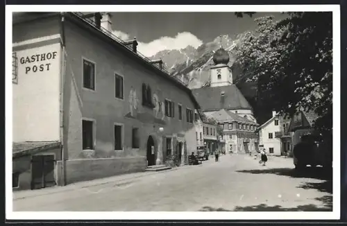 AK Gröbming, Strasse mit Gasthof Post und Kirche