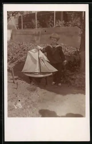 Foto-AK Kleiner Junge im Matrosenanzug mit Spielzeugboot