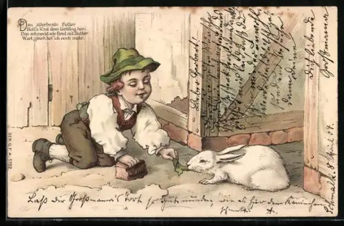 AK Kleiner Junge füttert sein Kaninchen