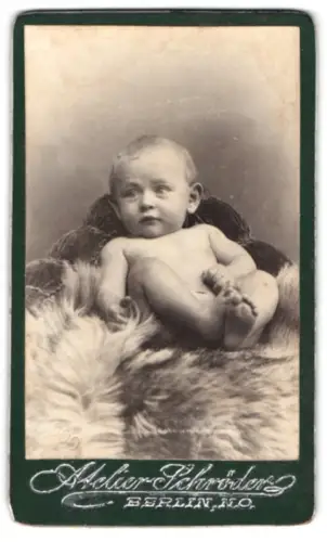 Fotografie Atelier Schröder, Berlin, Kind gemütlich auf Fell drapiert