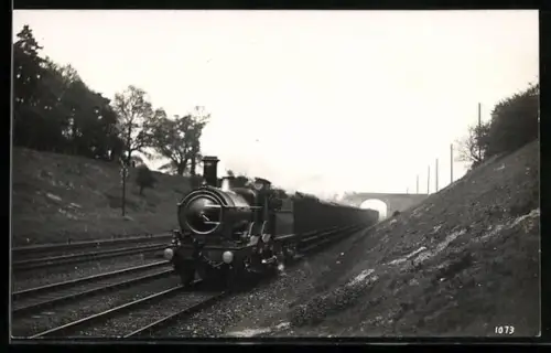 AK Britische Lokomotive Nr. 3213 mit Güterwaggons nach Unterfahren einer Brücke, englische Eisenbahn