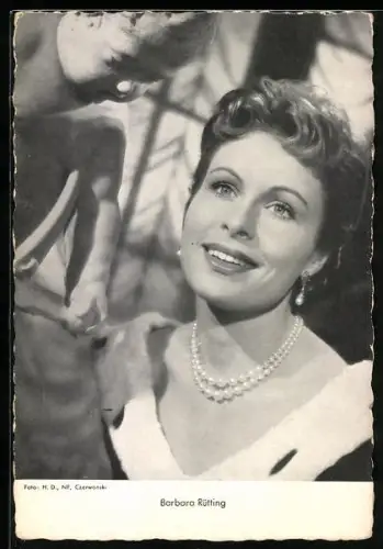 AK Schauspielerin Barbara Rütting lächelnd an einer Figur stehend