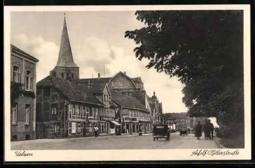 AK Uelzen, Strasse mit Geschäften und Kirchturm