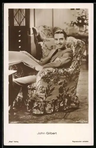 AK Schauspieler John Gilbert in einer Szene im Sessel sitzend
