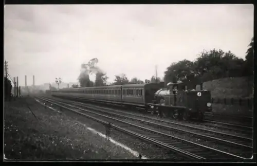AK Britische Lokomotive mit 13 Personenwaggons in Fahrt nahe Earlsfield, englische Eisenbahn
