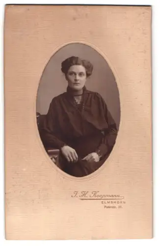 Fotografie J. H. Koopmann, Elmshorn, Peterstr. 37, Porträt einer Frau in dunkler Kleidung