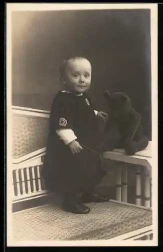 Foto-AK Kleinkind auf einer Bank mit einem Teddy