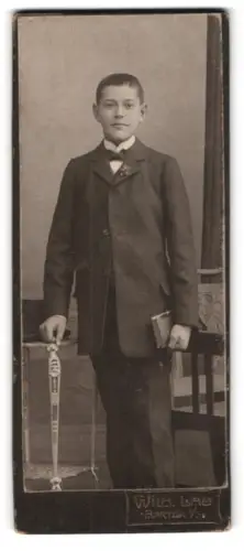 Fotografie Wilh. Lau, Hartha, Junger Mann im Anzug mit Buch