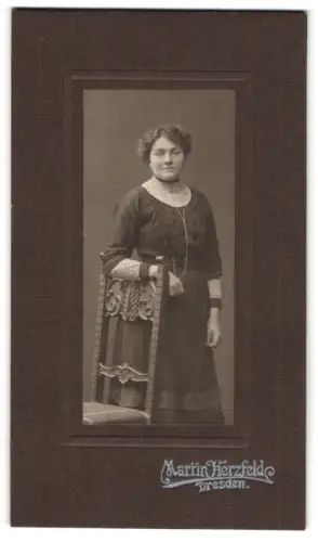 Fotografie Martin Herzfeld, Dresden, Pragerstrasse 7, Porträt einer Dame neben einem Stuhl 1912