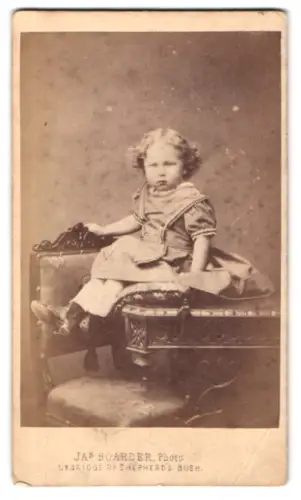 Fotografie Jas Boarder, Shepherd`s Bush, Uxbridge Road, Kleinkind auf einem Tisch sitzend