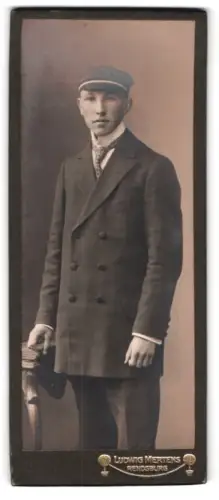Fotografie Ludwig Mertens, Rendsburg, Am Gymnasium, Eleganter Student im Anzug mit Tellermütze